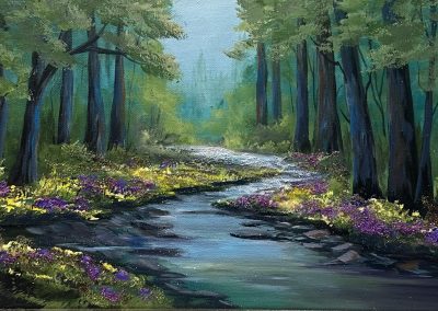 A tranquil woodland creek sparkles with glass and mica, framed by wildflowers and morning light filtering through trees.