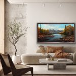 Fall landscape with aspen trees, gemstones, and calm water, soft mountains in the distance.