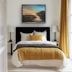 A glowing sunrise over water with golden reflections and shimmering accents of glass, glitter, and mica.