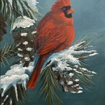 A vibrant red cardinal sits on a snow-covered pine branch in a teal winter sky. Mica and glass glitter add shimmering highlights to the feathers and snow. The artwork is framed in a sleek black floater frame.