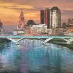 Panoramic mixed-media painting of the Columbus, Ohio skyline at dusk, viewed over the Scioto River with arched bridges and glowing reflections in the water. The artwork features glass and mica sparkle that catches the light, framed in a black floater frame.